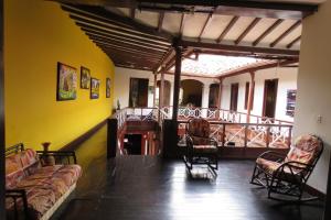 a living room with couches and chairs and a balcony at Casona Don Juan Hostel in San Gil