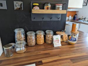 a kitchen counter with jars of food on it at South Downs View in Brighton & Hove