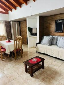a living room with a couch and a table at Departamento Centrico in Villa General Belgrano