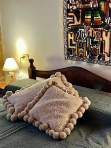 a bed with a pillow on top of it at Departamento Centrico in Villa General Belgrano
