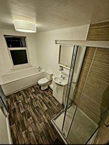 a bathroom with a toilet and a sink and a shower at Comfortable 2 Bed House Near City Centre and M1 in Leicester