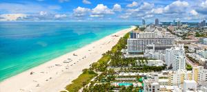 an aerial view of a beach with buildings and the ocean at Geneva Hotel in Miami Beach