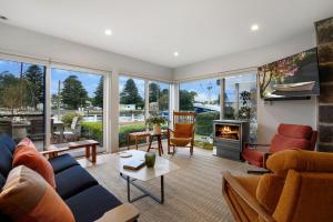 a living room filled with furniture and a fireplace at Steam Packet Wharf in Port Fairy