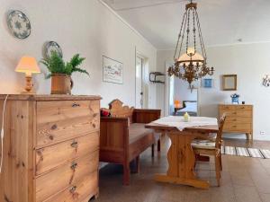 a dining room with a table and a chandelier at 5 person holiday home in Löttorp-By Traum in Löttorp