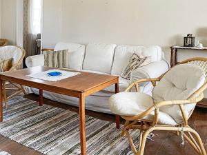 a living room with a white couch and a table at 9 person holiday home in Ljungbyhed-By Traum in Ljungbyhed +34 photos