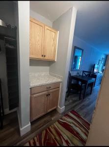 a kitchen with wooden cabinets and a dining room at Upgraded Studio at Landmark Resort ! 17 pools, lazy rivers, jacuzzis! 814 in Myrtle Beach