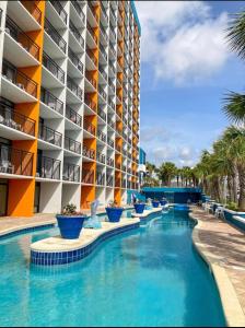 una piscina frente a un hotel en Upgraded Studio at Landmark Resort ! 17 pools, lazy rivers, jacuzzis! 814 en Myrtle Beach
