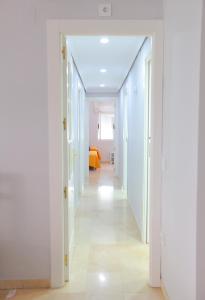 a hallway with white walls and a white floor at Albéniz in Córdoba