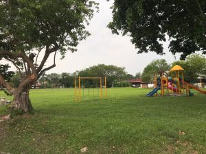 a park with a playground and a tree at Ipoh Canning Garden Simple House 4R3B 12pax SY19 in Ipoh