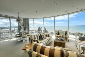 a living room with a view of the ocean at Marsden Suites Nautilus Orewa in Orewa