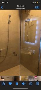 a shower with a glass door in a bathroom at Lovely chalet 4- bedroom directly on the lagoon in El Alamein