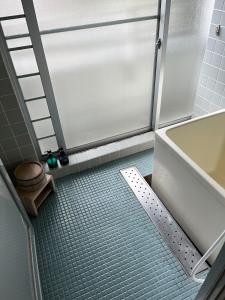 a bathroom with a shower with a toilet and a tub at Enmanin Sanmitsuden - Vacation STAY 03295v in Otsu