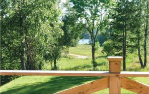a porch with a view of a field and trees at 3 Bedroom Stunning Home In Färgelanda in Muberg