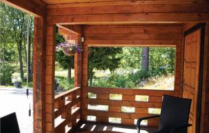 a screened in porch with two chairs and a window at 3 Bedroom Stunning Home In Färgelanda in Muberg