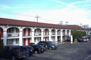 a building with cars parked in a parking lot at Cabana Inn - Boise in Boise