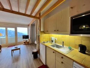 a kitchen with a sink and a counter top at Studio Villard-de-Lans, 1 pièce, 6 personnes - FR-1-515-166 in Villard-de-Lans