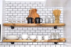 a shelf with dishes and glasses on a wall at New York Suite III at Avida Towers Aspira in Cagayan de Oro