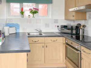 a kitchen with a sink and a counter top at Chalet 54 in Cromer