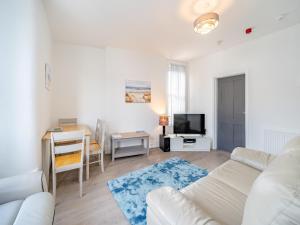 a living room with a white couch and a table at Two - Uk43700 in Saint Annes on the Sea