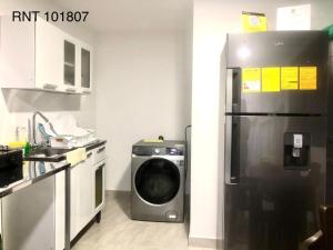 a kitchen with a refrigerator and a washing machine at El Bambu in Santa Rosa de Cabal +13 photos