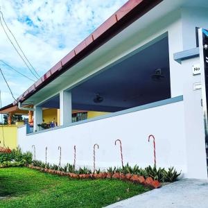 a white building with a large window on the side of it at Stay Inn Sikamat (Seremban Homestay) in Seremban