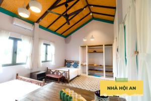 a bedroom with a bed and a table in a room at Wonder Farm Ba Vi - Heritage Retreat in Hà Lộc