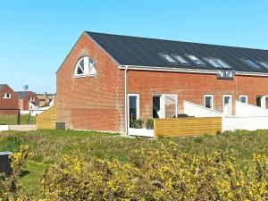 a red brick house with solar panels on it at 5 person holiday home in R m in Rømø Kirkeby