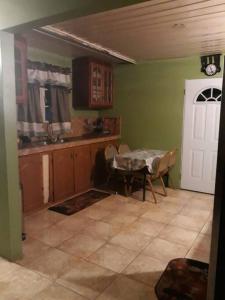 a kitchen with a table and a dining room at Spacious Home in Couva