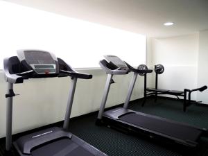 two treadmills in a room with a gym at Grand Hotel Victoria in El Morro de Barcelona