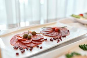 two plates of food on a white plate at Hotel Lovran in Lovran