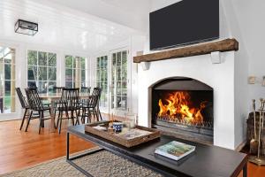 a living room with a fireplace with a tv at Glen Regan Berrima in Berrima