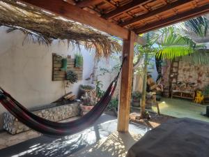 a hammock in the middle of a living room at Pousada e Hotel Italian Garden House in Campo Grande
