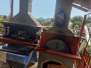 a large wood fired pizza oven on a patio at Vasiliki in Dhílesi