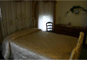 a bedroom with a bed and a dresser and a chair at Tarry Here Mansion Bed & Breakfast in Salamanca
