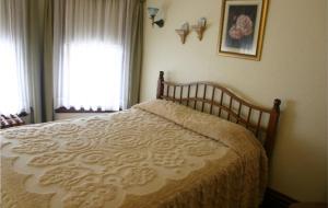 a bed in a bedroom with a window and a bedspread at Tarry Here Mansion Bed & Breakfast in Salamanca