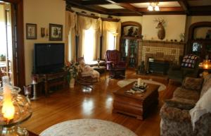 a living room with a couch and a tv at Tarry Here Mansion Bed & Breakfast in Salamanca