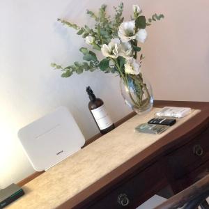 a table with a bottle of wine and a vase with flowers at Suite BA38 Departamento de Estilo en Microcentro in Paraná