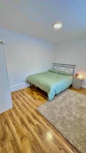a bedroom with a bed and a wooden floor at Cozy home in a peaceful area in Hayes