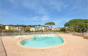 a large swimming pool in a brick patio at Amazing Apartment In Sainte-Maxime in Sainte-Maxime