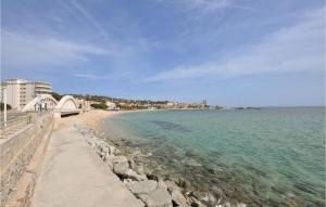 a beach next to the ocean with a bridge at Amazing Apartment In Sainte-Maxime in Sainte-Maxime