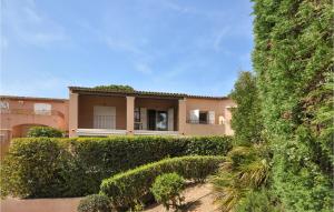 a large house with bushes in front of it at Amazing Apartment In Sainte-Maxime in Sainte-Maxime