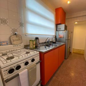 a kitchen with a stove and a refrigerator at Suite BA38 Departamento de Estilo en Microcentro in Paraná +52 photos