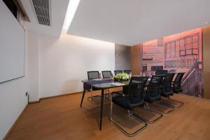 a dining room with a black table and black chairs at From K Huan Kai Hotel Tiyuxi Metro Station- Free transportation during the Canton Fair in Guangzhou