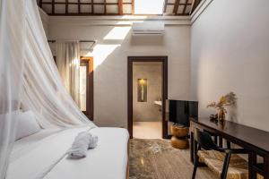 Säng eller sängar i ett rum på Rumah Ananda Bali