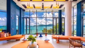 a room with a large window with a view of the ocean at Sri Panwa Phuket Luxury Pool Villa Hotel - SHA Plus in Panwa Beach