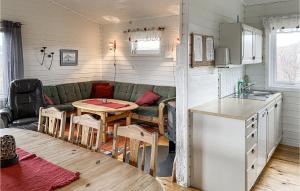 a kitchen and a living room with a couch and a table at Beautiful Home In Offersøy With Sauna in Offersøy