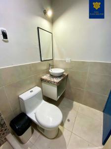 a bathroom with a white toilet and a sink at Casa Plaza Bolívar in Quillabamba