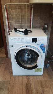 a washing machine with a book on top of it at Appartement Rose in Liezen