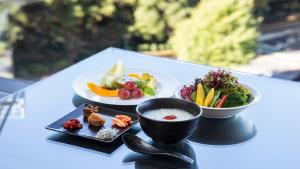 a table with two plates of food and a bowl of soup at Hotel New Otani Tokyo EXECUTIVE HOUSE ZEN in Tokyo