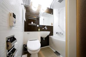 a bathroom with a white toilet and a sink at Travelodge Kyoto Shijo Kawaramachi in Kyoto